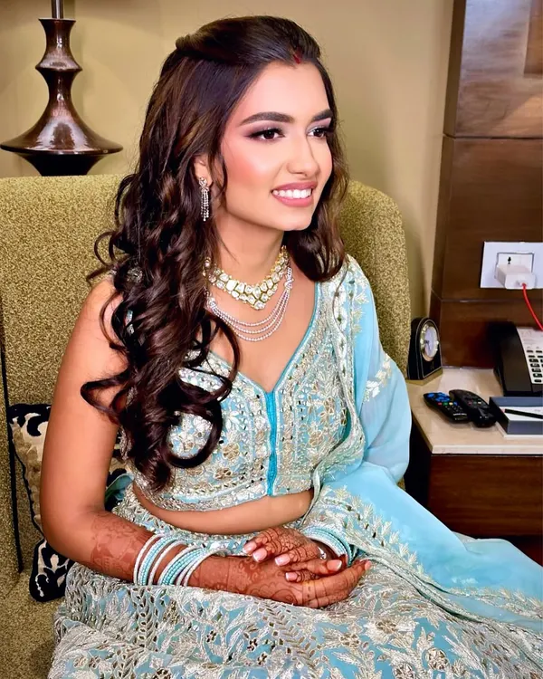 The perfect soft glam for a reception. This look features a dewy, flawless base, softly defined eyes, and a natural lip color, letting her beautiful smile and stunning lehenga shine.