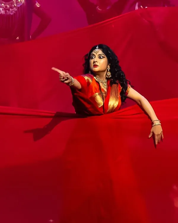 A dramatic moment from our production of 'Krishnaa', where I portray Draupadi. The use of a simple prop like this vast red cloth can create powerful, symbolic imagery on stage, telling a story of turmoil and emotion.