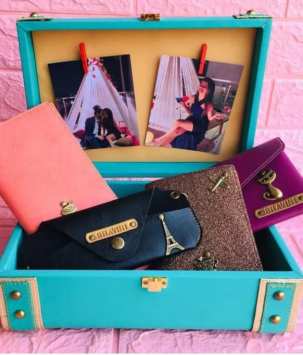A travel accessories hamper I customized for a client, packed in a beautiful turquoise trunk. It includes personalized passport covers and wallets, with photos clipped inside for an extra personal touch.