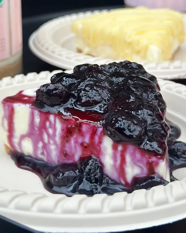 Our best-selling eggless Blueberry Cheesecake, featuring a rich, creamy texture and topped with a generous amount of our vibrant, house-made blueberry compote.