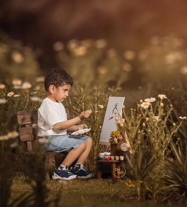 I believe in letting a child's imagination lead the way. For this outdoor session, we set up a small easel in a field of wildflowers and let this little artist paint his world. It’s a perfect example of a personality portrait that tells a unique story about your child.