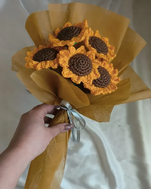 A full bouquet of our handmade crochet sunflowers, held together and ready to be gifted. The vibrant yellow and rich brown centers are designed to look just like the real thing, but these will brighten your home forever.