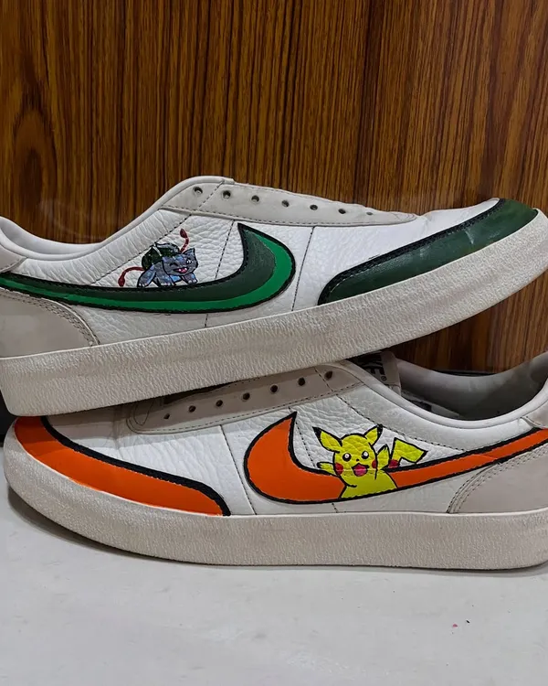 A side-by-side view of the custom Pokémon-themed Nikes. This angle shows how the designs on each shoe complement each other, creating a cohesive pair of hand-painted sneakers.