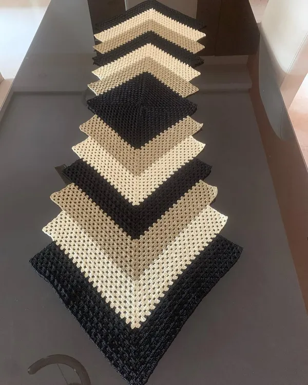 This chevron or ripple pattern table runner is one of my most popular modern designs. The mix of black, beige, and cream creates a sophisticated look that elevates any table.