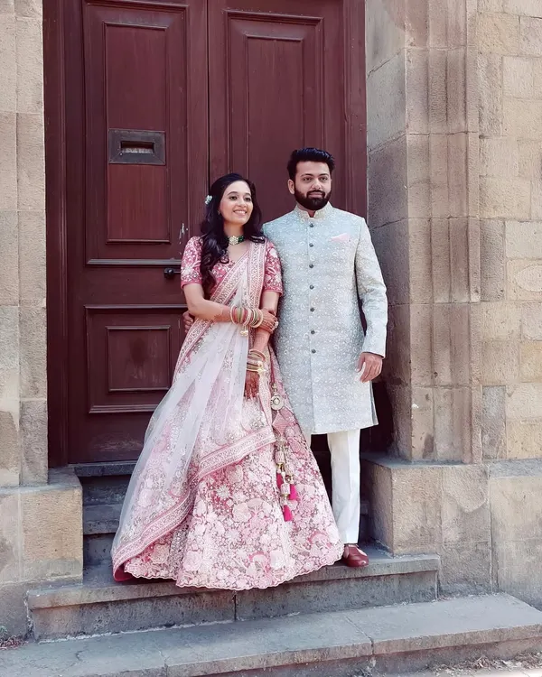 A perfect pair ready for their wedding day. The bride's soft pink look and the groom's elegant sherwani create a timeless portrait.