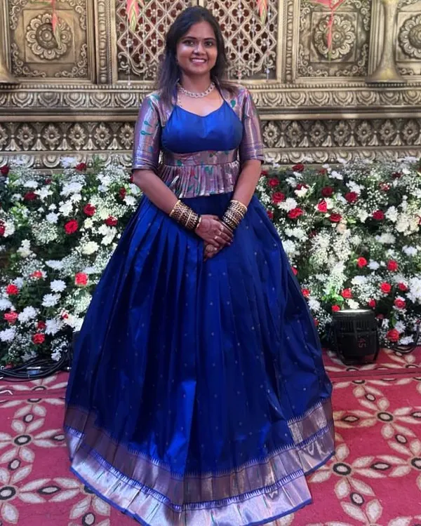 For Shravya's reception, we created this entire peplum blouse and lehenga set in just one day. The peplum top is made from a contrasting fabric for a modern look.