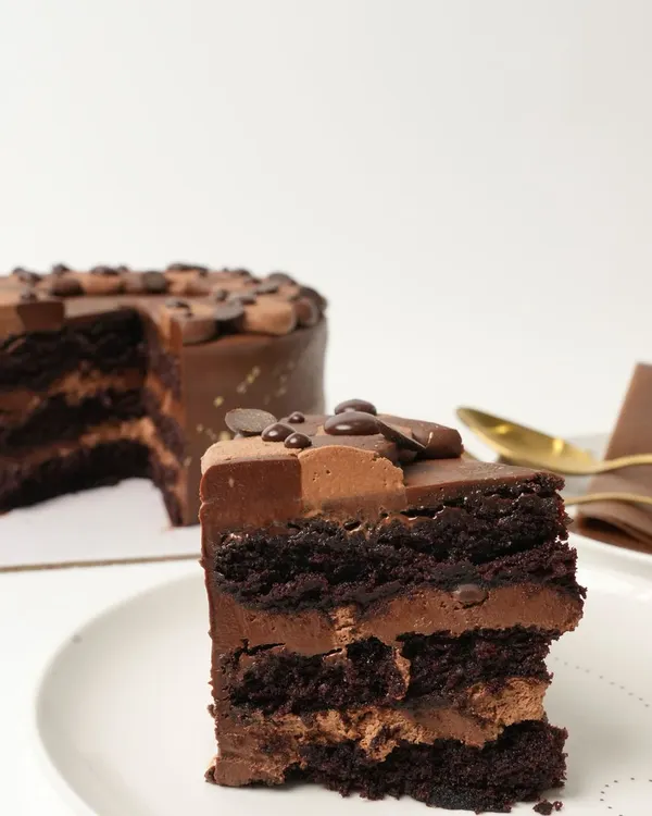 My most-loved Belgian Chocolate Mousse Cake. It is made with moist layers of chocolate sponge, chocolate chips, and a light-as-air chocolate mousse, all covered in a rich Belgian chocolate ganache.