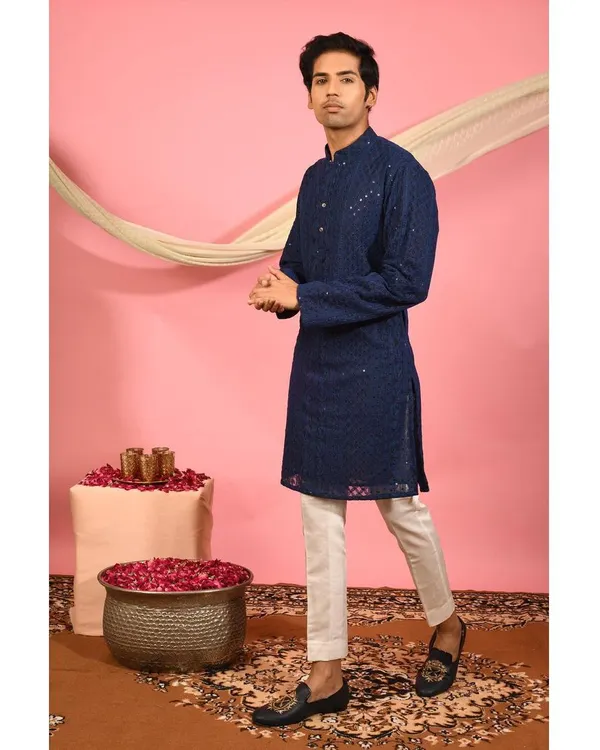 My navy blue chikankari kurta, shown here as a complete outfit. The classic silhouette is enhanced with all over embroidery and subtle mirror work, offering a timeless look for any festive occasion.