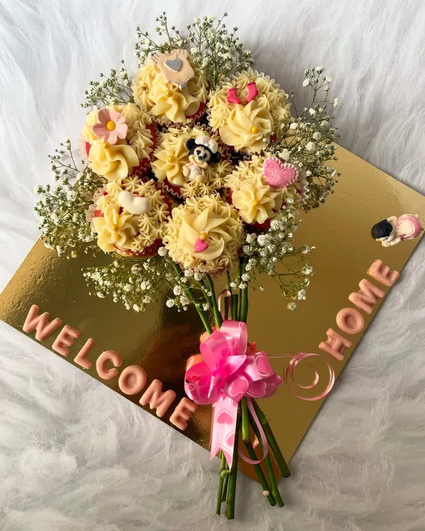 A beautiful and delicious way to say "Welcome Home." Our custom cupcake bouquets are handcrafted with fresh flowers and your choice of eggless cupcakes, making any occasion truly special.