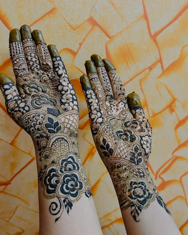A classic Indo-Arabic design where bold floral and leaf motifs create a flowing pattern. The contrast between the dark, thick outlines and the skin is a hallmark of this style.