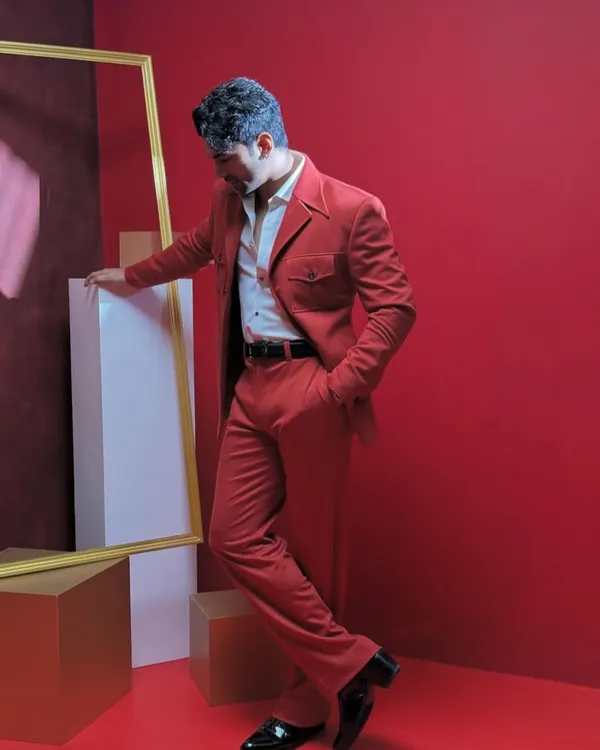 A striking red suit designed for making a confident statement. The unique pocket details and sharp tailoring demonstrate our ability to blend classic structure with bold, modern style.