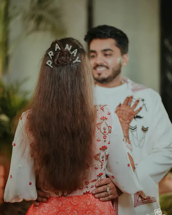 A sweet, personalized detail. The bride's custom hairpins spell out the groom's name, a small touch that we love to incorporate to make the day uniquely theirs.