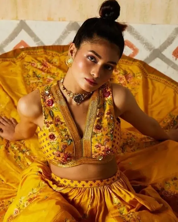 A captivating shot from a designer lookbook, where the makeup enhances the model's direct gaze. I used warm tones and a dewy finish to complement the rich yellow and intricate embroidery of the ensemble.
