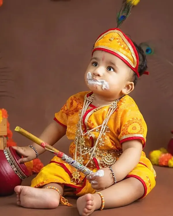 A baby dressed as little Krishna for a Janmashtami festival shoot, with a bit of "butter" on his face.
