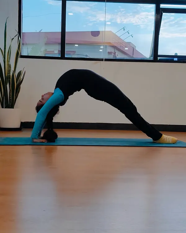 Meet Charvi, our very first kids' yoga student. Here she is in a graceful wheel pose, a symbol of the strength and confidence she has built since she first walked into our studio.
