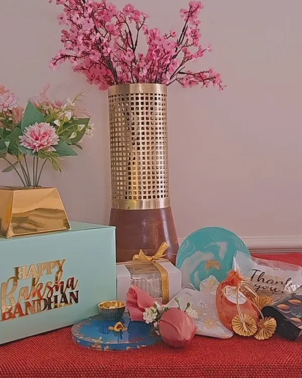 Announcing my exclusive, limited-edition Rakhi hamper boxes. This flat-lay shows a sample of what can be included, from artisanal candles and coasters to trinket trays and a resin thali.