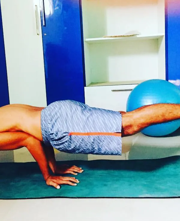 Core strength is the center of a player's power and stability. This image shows an advanced balancing exercise that builds the core and upper body strength essential for controlled, powerful shots on the court.