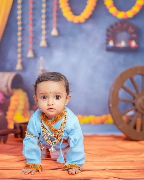 **Hero Item:** I offer creative, themed baby photoshoots like this Krishna-inspired session. This setup in my Bangalore studio includes custom backdrops, traditional props, and costumes to create truly memorable milestone portraits for your child.