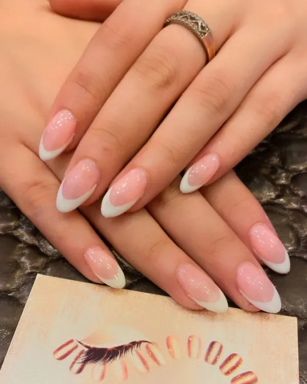 The perfect classic French manicure on medium-length almond nails. This design features a clean, sheer pink base and crisp white tips for a timeless and elegant look.