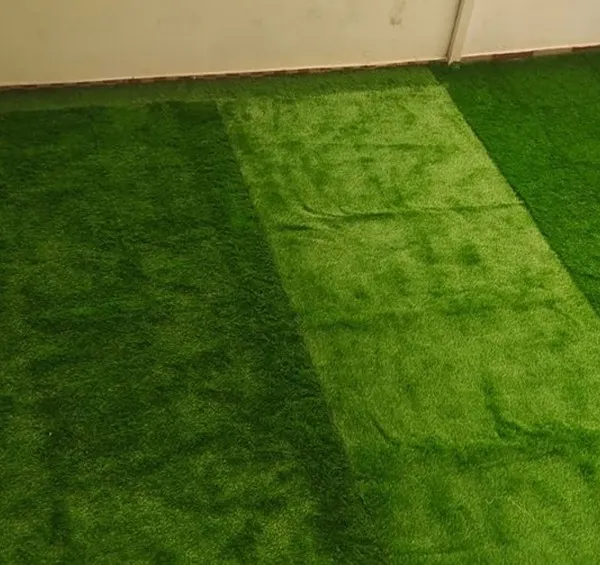 The final result of an artificial grass installation on a spacious balcony. It completely transforms the look and feel of the space, making it soft, green, and inviting.