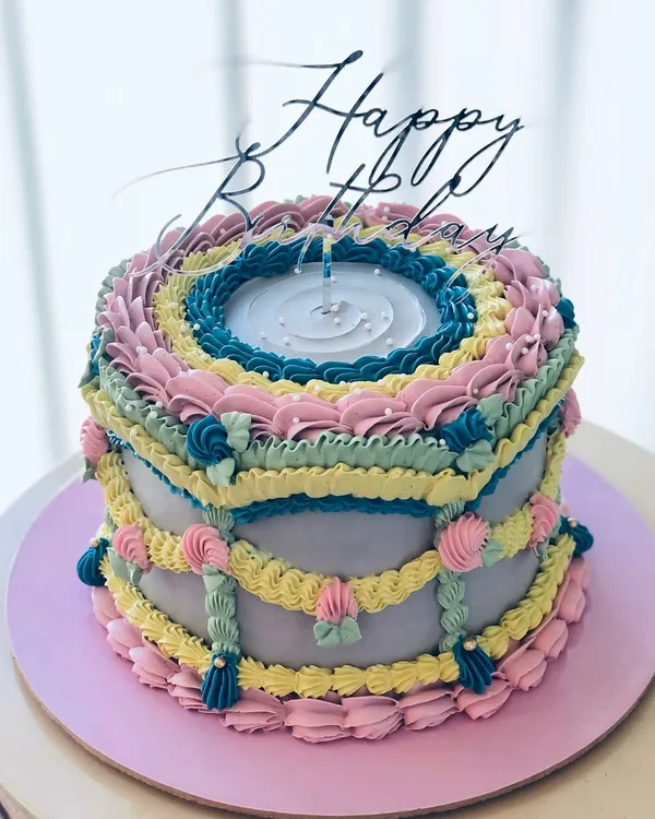 I call this "Vintage Maximalism." A colorful take on the classic Lambeth piping style, with layers of intricate buttercream details.
