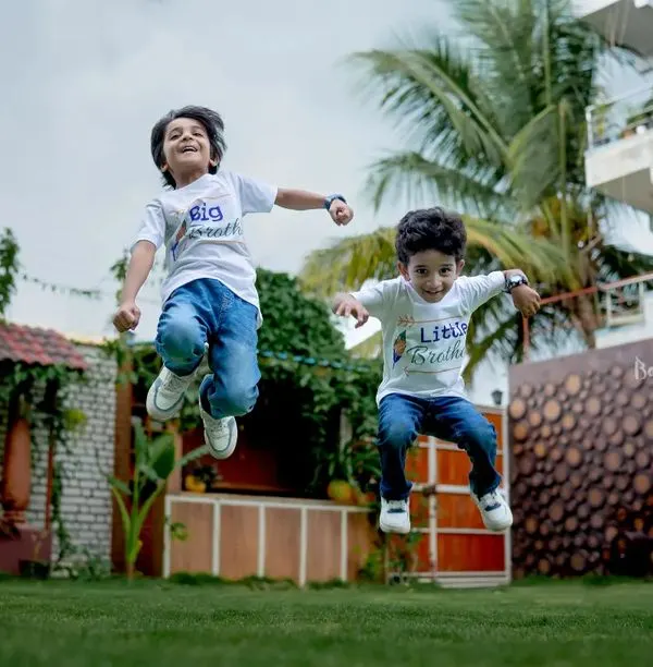 Double the giggles, double the grins! Capturing the boundless energy of these two brothers as they jump for joy during their outdoor kids photoshoot.