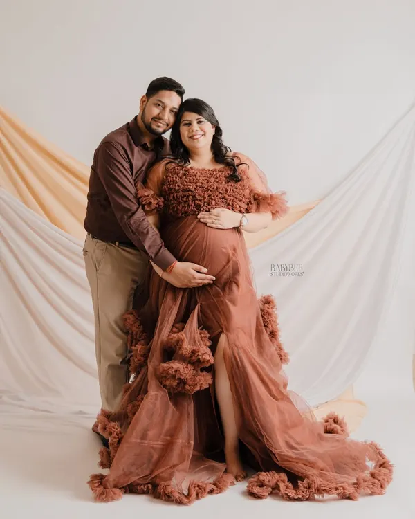We believe in capturing the dream you've been waiting for. This portrait showcases one of our beautiful maternity gowns, perfect for creating a glamorous and romantic look that celebrates you and your partner.