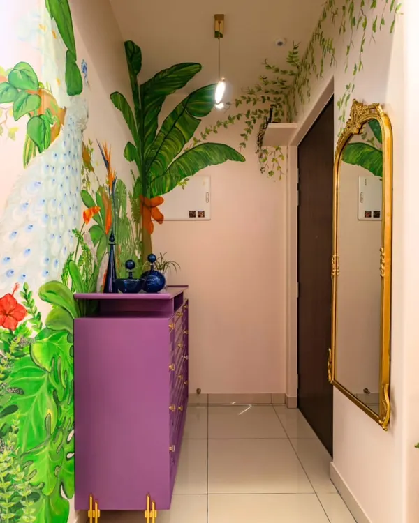 The foyer is the first chapter of a home's story. For this entrance, we painted a breathtaking mural featuring a peacock amidst lush jungle foliage. The vibrant colors and intricate details immediately draw you in and set a tone of artistic elegance.