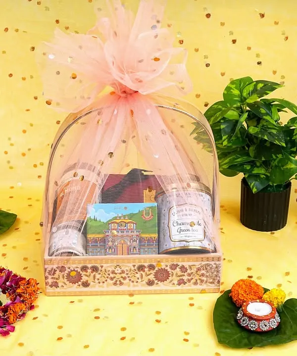 A beautifully styled shot of a festive gift hamper, complete with diyas and floral decorations. This type of photography is perfect for seasonal promotions and making your gift items look irresistible.