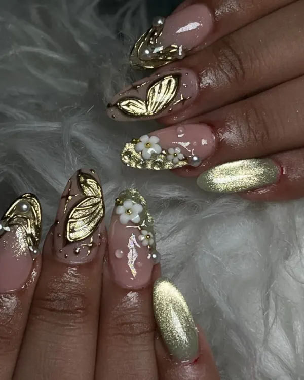 A truly unique set with 3D elements. I sculpted golden butterflies and small white flowers, pairing them with a gold cat eye accent nail for a magical vibe.