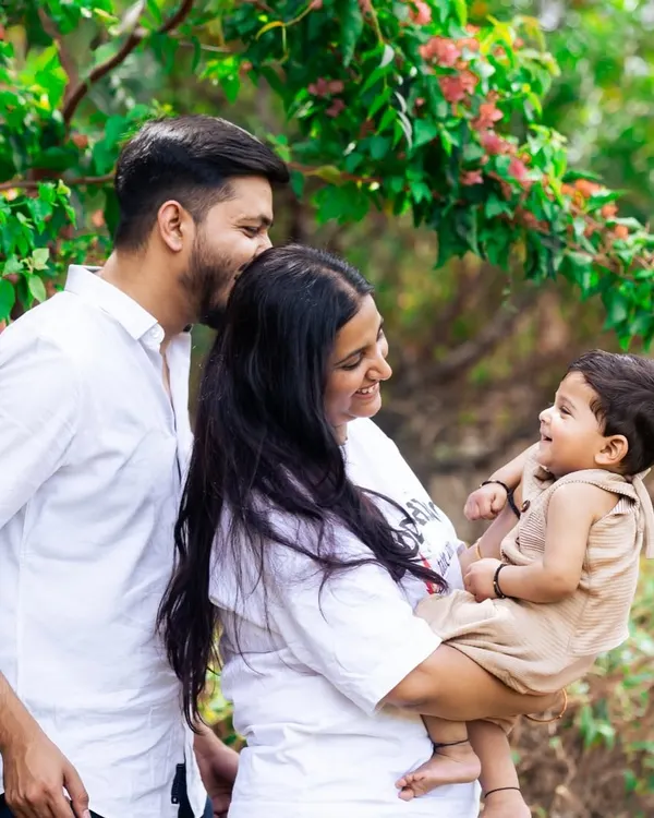 A candid family moment captured under the trees. Outdoor sessions like this allow for natural interaction and result in warm, authentic family portraits full of love and laughter.