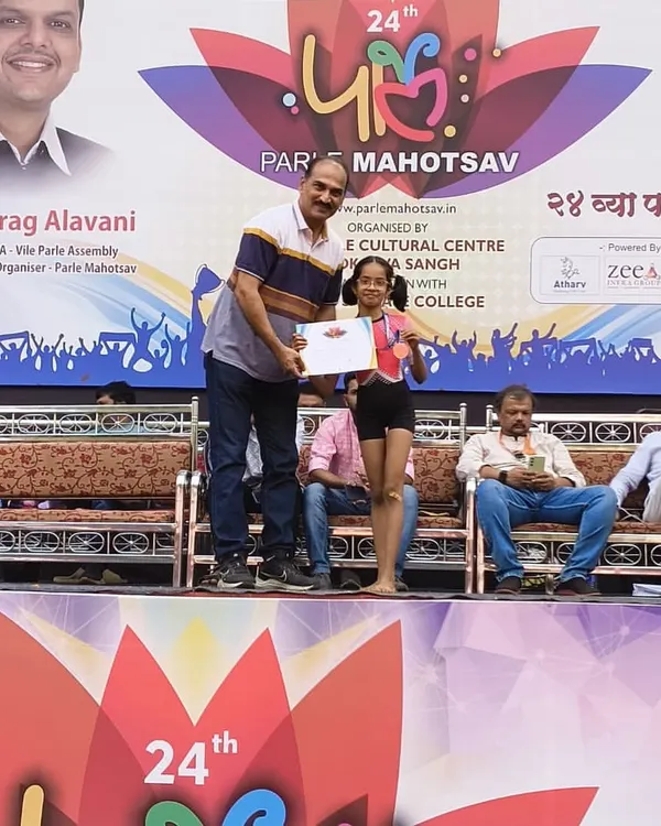 A moment of pride at the 24th Parle Mahotsav. One of our talented young students, Shivani Munda, receives her gold medal on stage. Her victory in the 9 to 14 girls' category is a win for the entire academy.