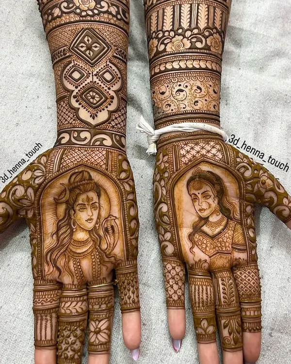 A divine portrait design featuring Lord Shiva and Goddess Parvati on opposite palms. This is a beautiful way to incorporate spiritual elements into your bridal mehndi.