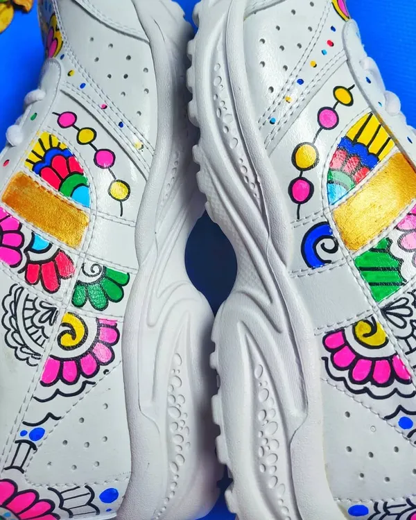 A pair of plain white sneakers transformed with vibrant, hand-painted floral and mandala-inspired patterns, showcasing my custom wearable art service.