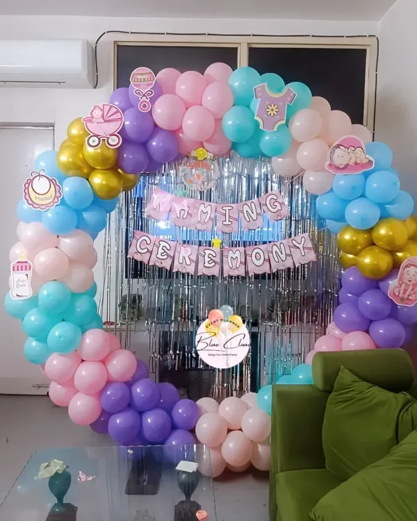 A beautiful and colorful balloon ring for a Naming Ceremony. We used a mix of pastel balloons and a silver fringe curtain to create a joyful and celebratory backdrop.