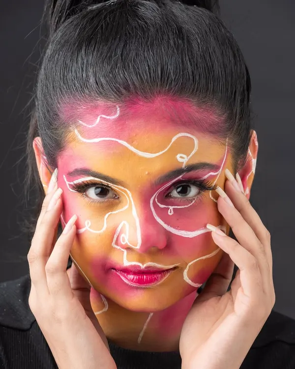 This abstract face art is a perfect example of turning a face into a canvas. Students learn to use line work and color blocking to create visually striking, artistic designs.