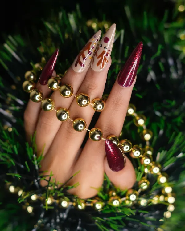 This Christmas-themed set features a mix of sparkling red glitter and nude polish on long stiletto nails. The hand-painted reindeer on the accent nails adds a playful and festive element.