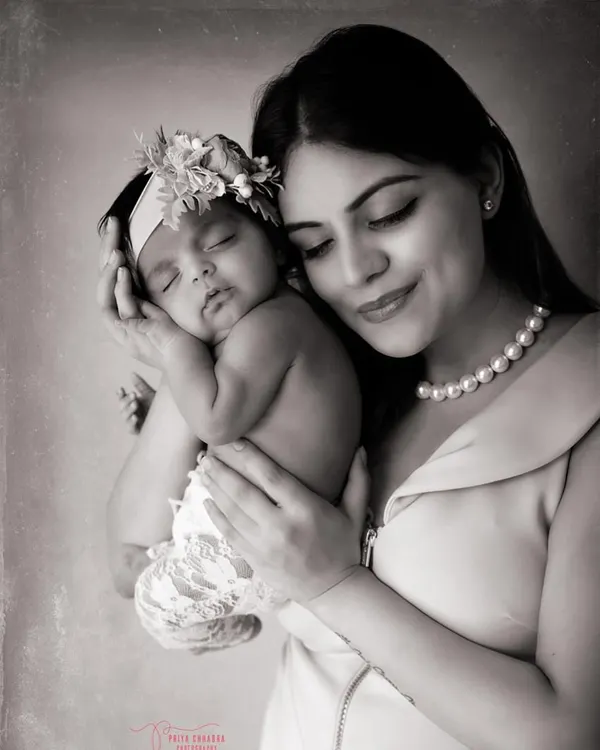 The quiet magic between a mother and her newborn. A black and white portrait strips away everything but the soft light and even softer love.