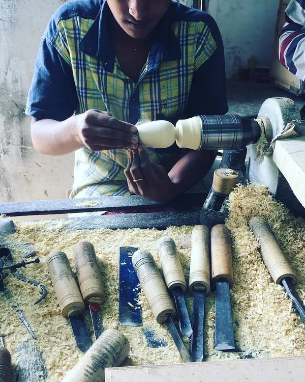 A young artisan carefully works on a new design. We are constantly blending traditional techniques with fresh ideas, ensuring the craft of Channapatna continues to evolve while honoring its roots.