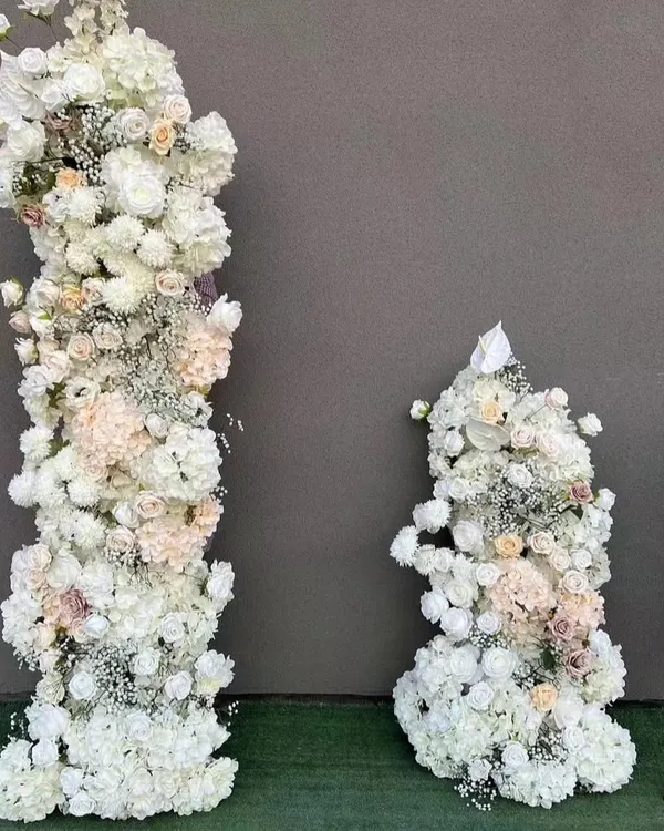 These tall, freestanding floral pillars are made with artificial white flowers and are ideal for high-impact event decor. I use them to frame stages, create grand entrances, or line wedding aisles.
