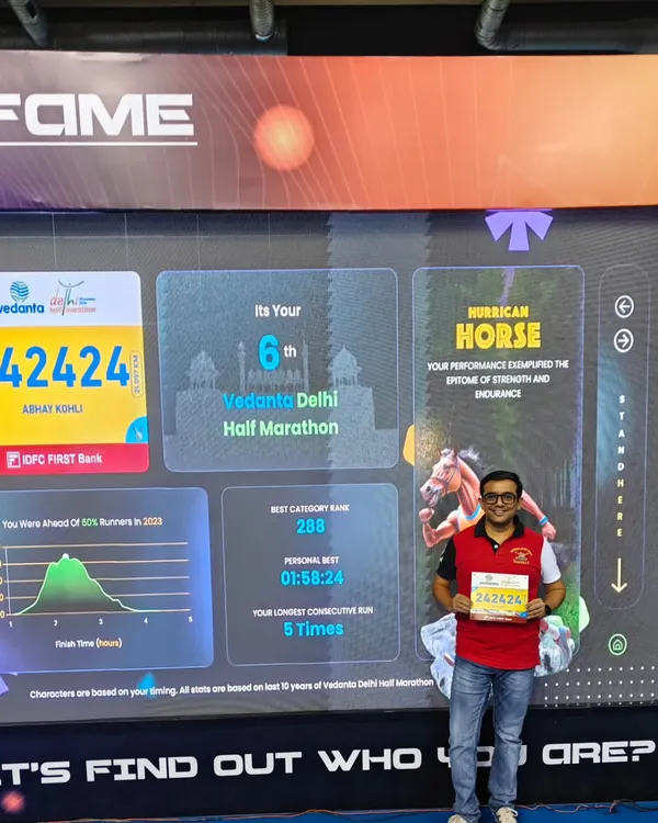One of our runners at the Vedanta Delhi Half Marathon (VDHM) expo, showing his impressive race history. We are proud of our members' consistency and dedication.