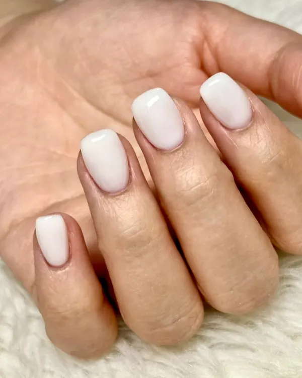 The perfect milky white manicure. This clean and simple look on short, square-shaped nails is the essence of the "clean girl" aesthetic: understated, elegant, and effortlessly chic.