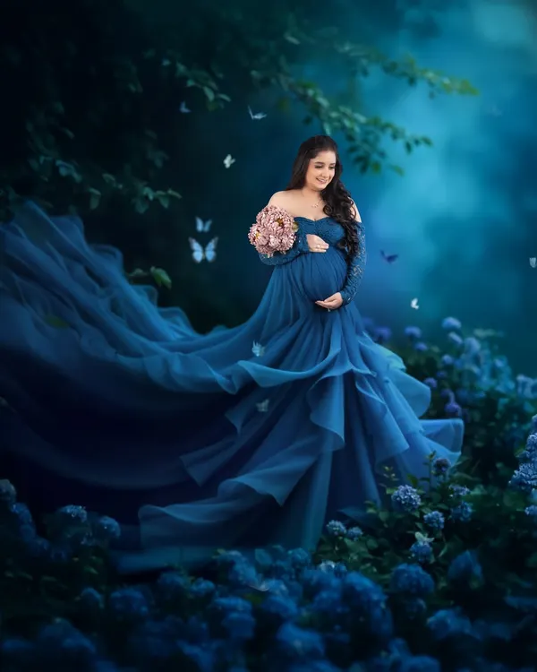 This is the kind of magic I love to create. We found the perfect flowing blue gown from my studio collection and created this dreamy, fairytale moment to celebrate her pregnancy glow. It’s all about making you feel absolutely beautiful.
