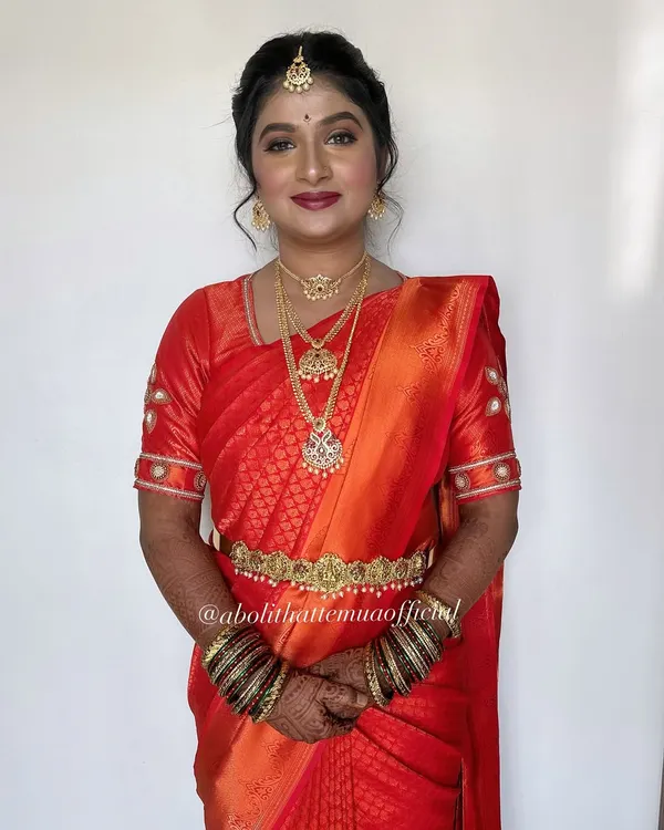 A classic South Indian bridal look. I used warm tones and a bold red lip to complement her beautiful Kanjeevaram saree and traditional temple jewelry.
