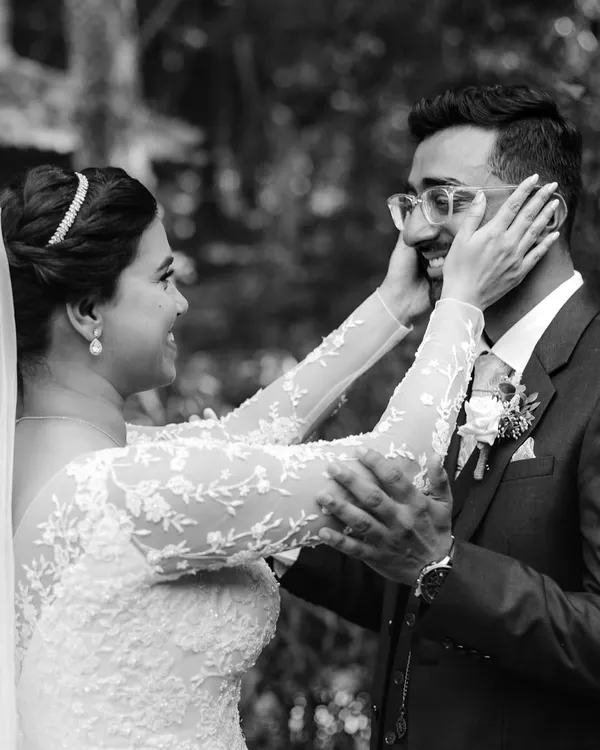 The first look. This black and white photo captures the bride's hands framing the groom's face as they see each other for the first time. It's an incredibly personal and emotional moment that I feel honored to witness.