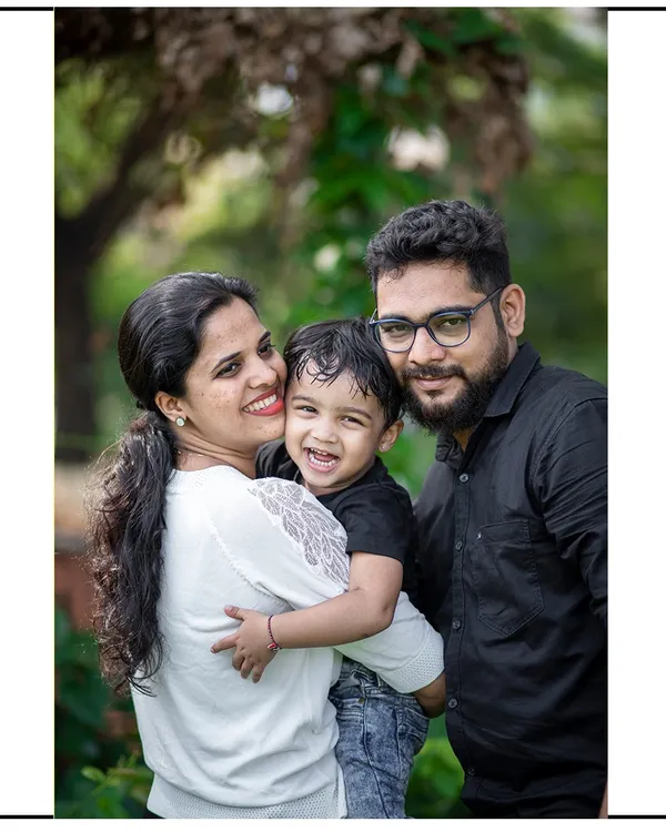 A classic family portrait where everyone's joy shines through. We found a lovely spot in the park, and the natural light created this warm, happy photograph.