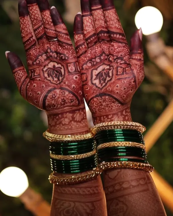 The result of my natural henna is a deep, rich stain. This photo shows the beautiful dark color on the palms, complemented by traditional green bangles.