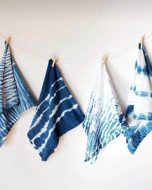 These are some of my naturally dyed napkins, each with a unique pattern from the shibori tie-dye technique. I've been working with indigo for two years, and its rich, deep blue color is truly special. They are perfect for adding a touch of handmade charm to your table setting.