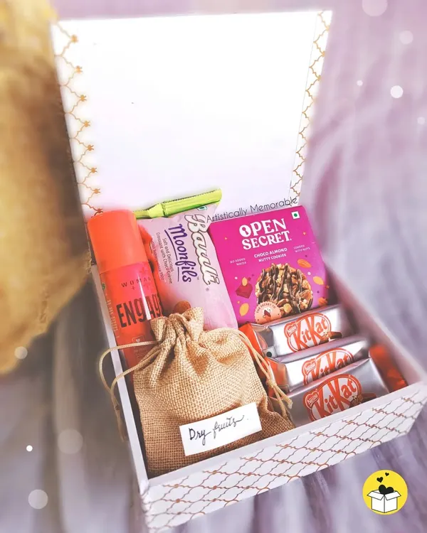 Inside my special Rakhi hamper for sisters. It's packed with a perfume, sweet and savory treats, and a little pouch of dry fruits for a healthy touch.