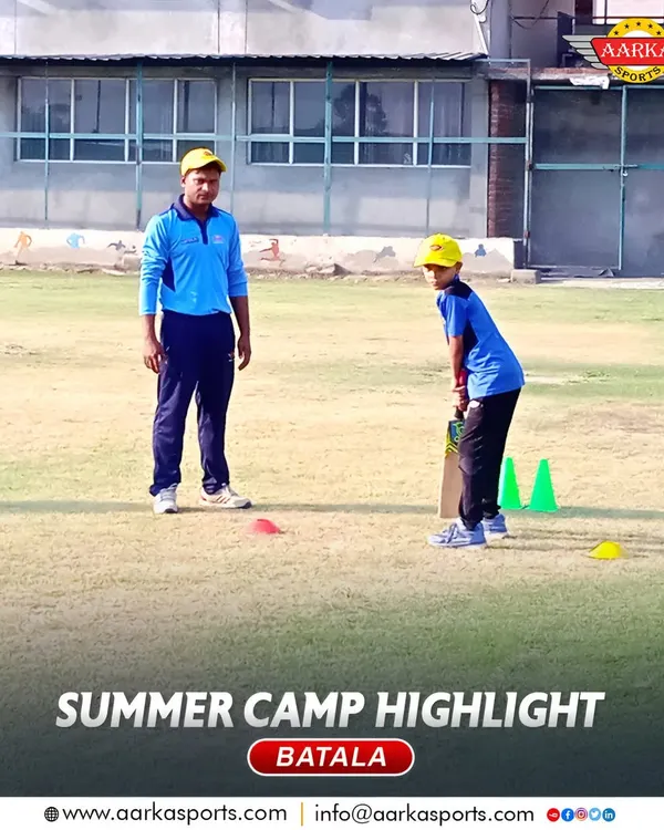 A coach provides one-on-one batting instruction during our Batala summer camp. This personalized attention is a cornerstone of our coaching philosophy.